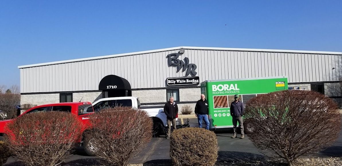 A group of people are standing in front of a large building.