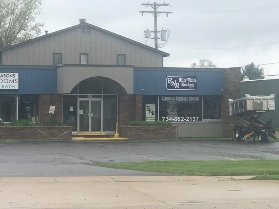 A horse drawn carriage is parked in front of a building