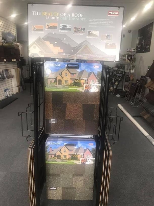 A display of carpets in a store with a sign that says `` the beauty of a roof ''.