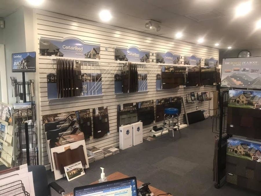 A store filled with lots of products and a desk with a laptop on it.