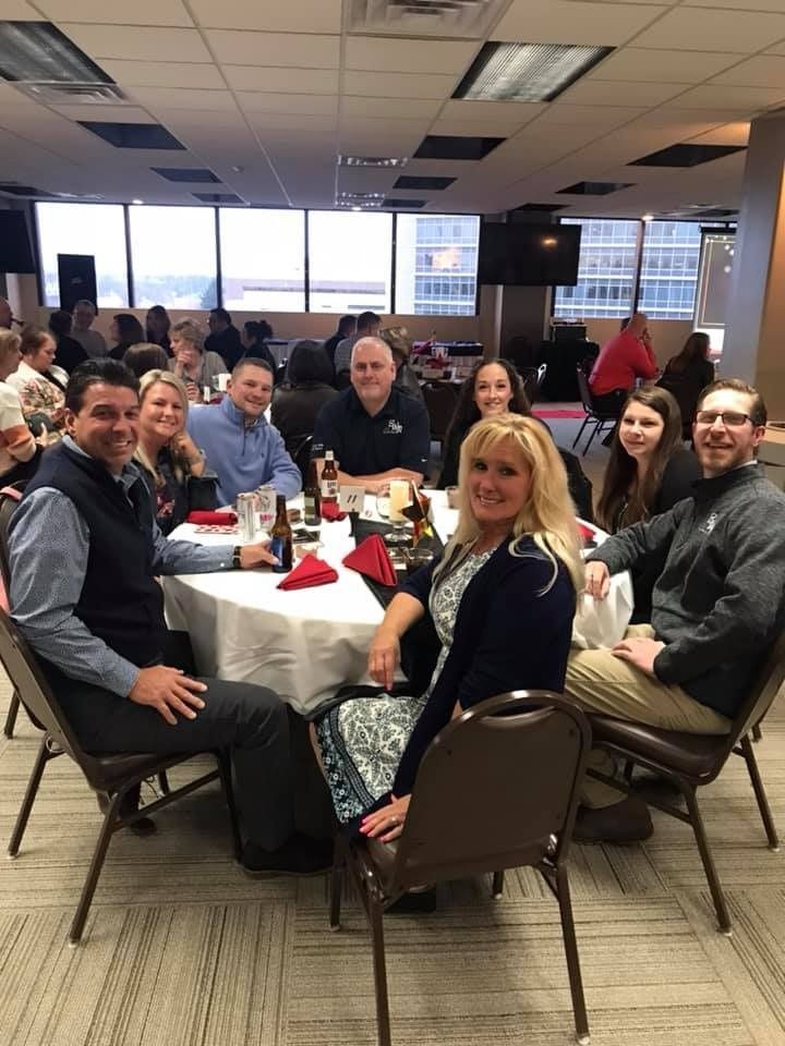 A group of people are sitting at tables in a room.