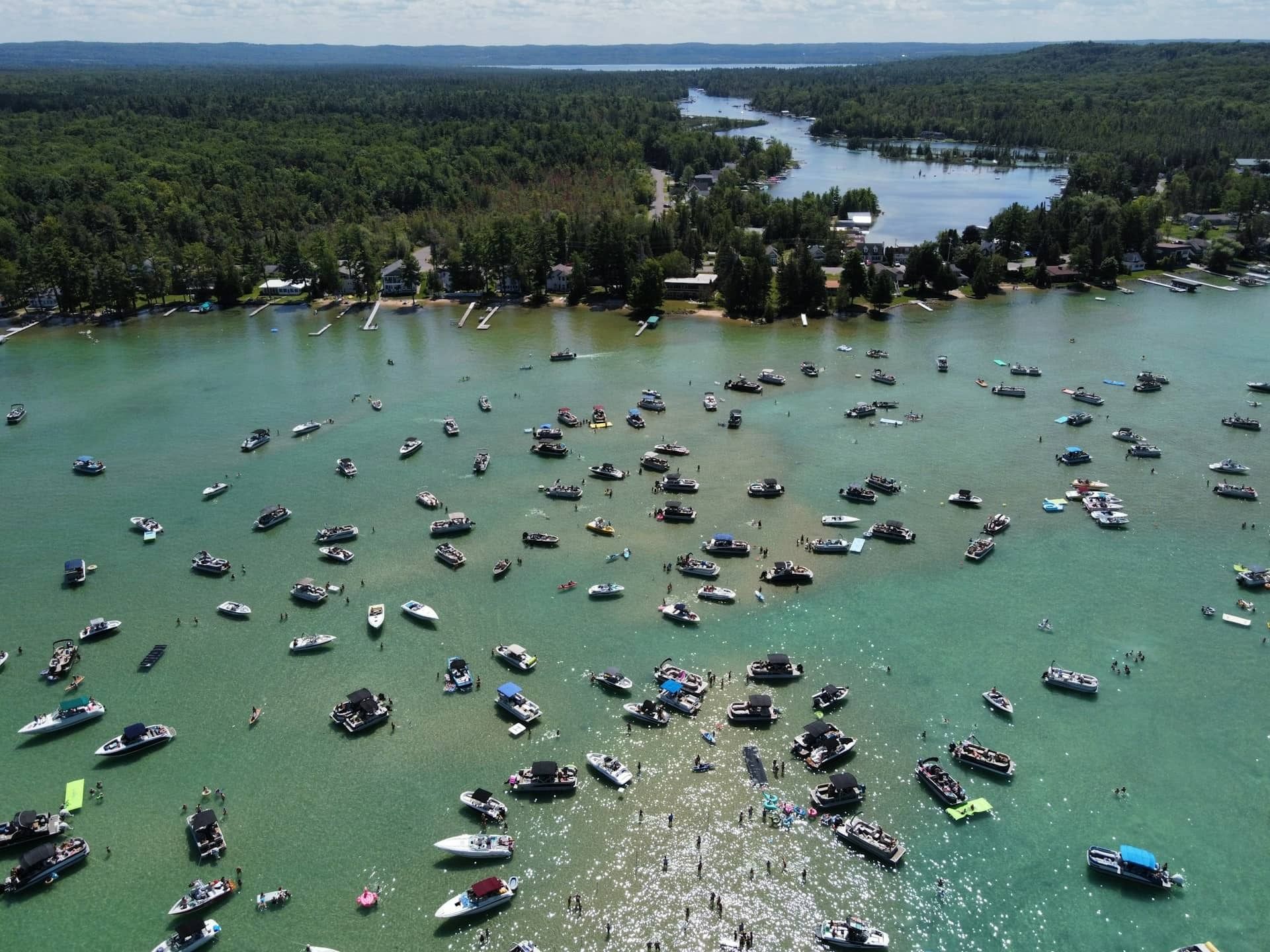 An aerial view of a lake filled with lots of boats
