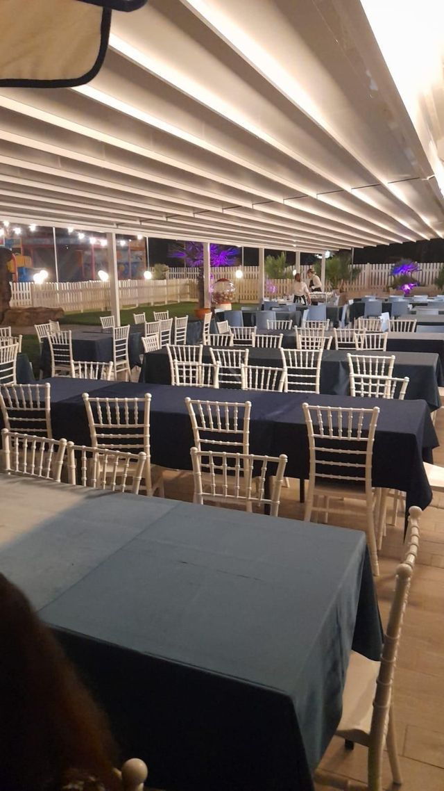 Un ristorante con tavoli e sedie allestito per una festa.