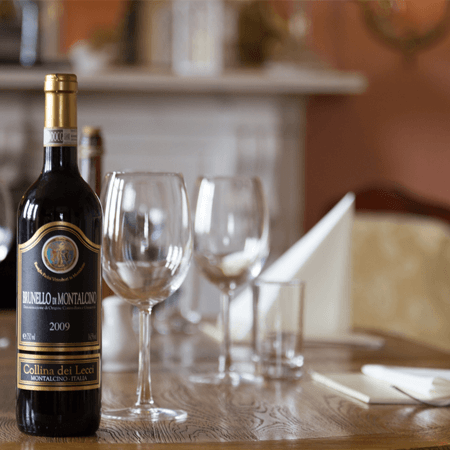 Wine bottle and glasses on restaurant table
