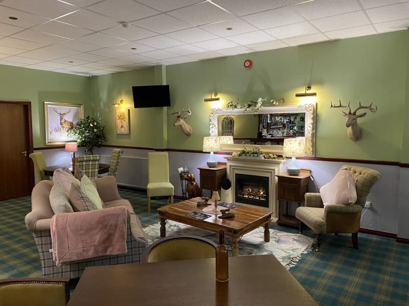 Sitting room with two couches, coffee table and fire place