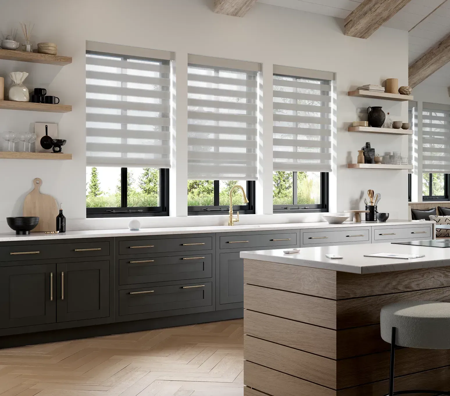 Modern kitchen with dark cabinets, light countertops, and dual-shade blinds.