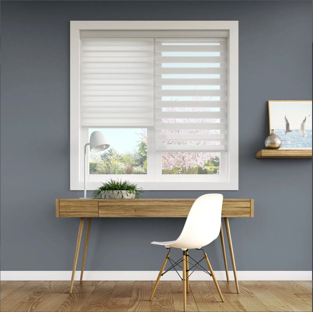 White office space with desk, chair, window with blinds, and artwork.