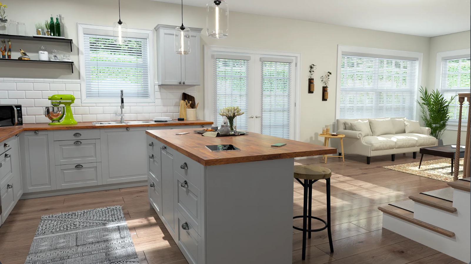 A bright, open kitchen with a light gray island and cabinets, a wooden countertop, and a living area.