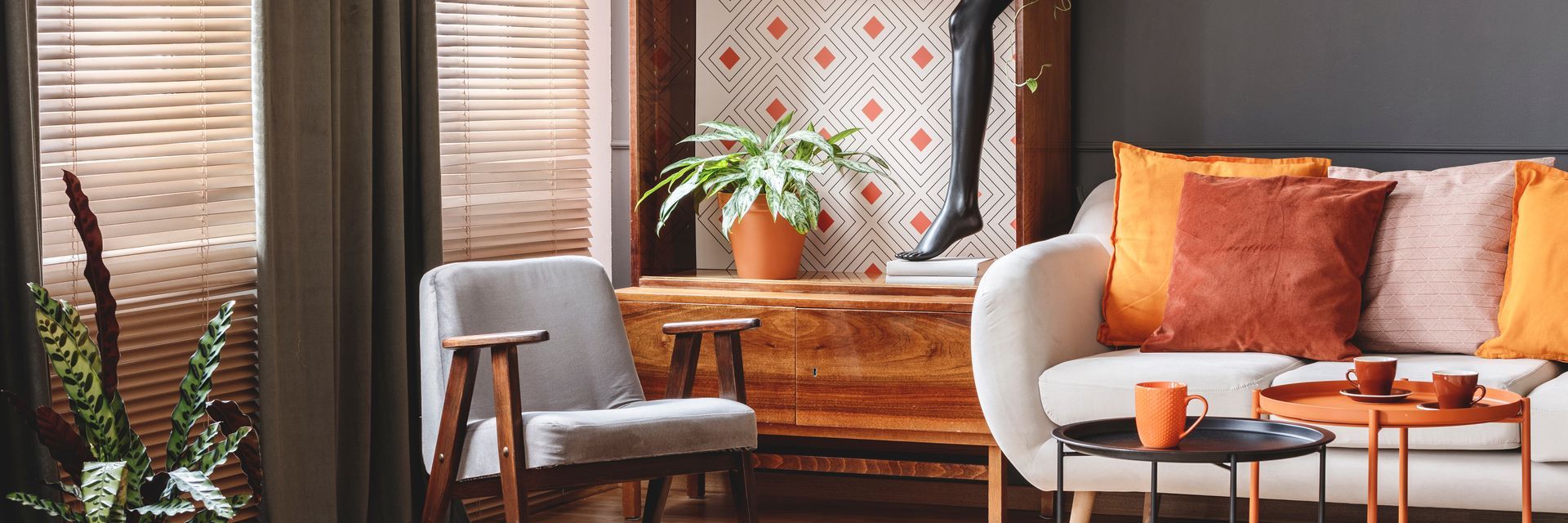 Living room with layered window treatments, sofa, and accent chair. 