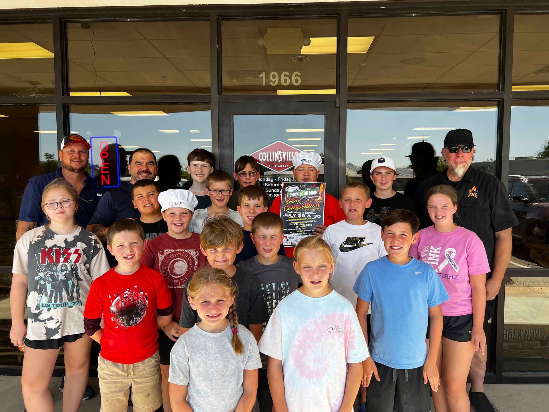 A group of children are posing for a picture in front of a building.