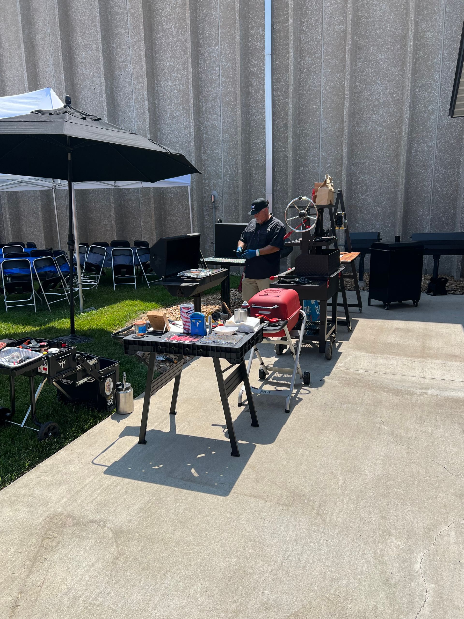 A man is standing in front of a table with a laptop on it.