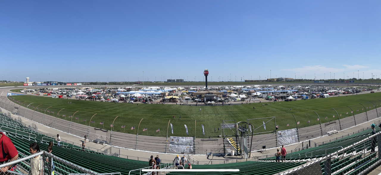 A panoramic view of a race track from the stands.