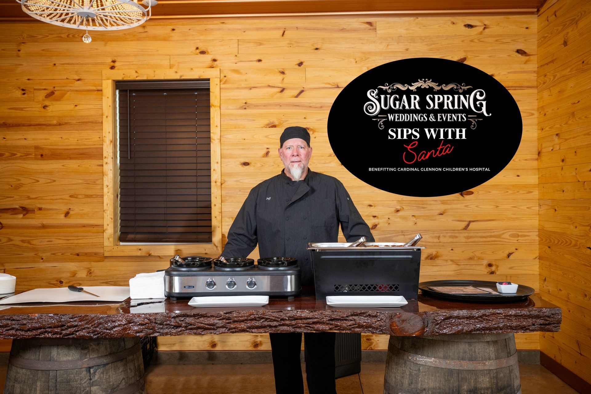 A man is standing in front of a sign that says sugar springs