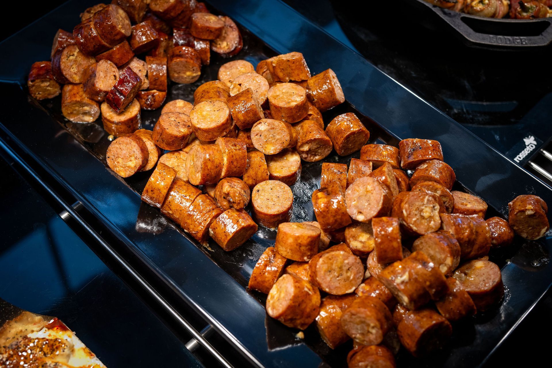There are many different types of sausages on a tray.