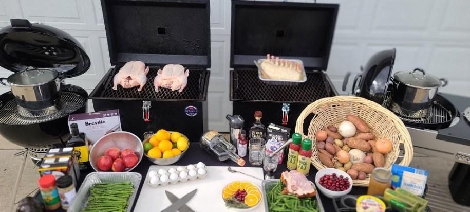 Two grills are sitting on top of a table filled with food.
