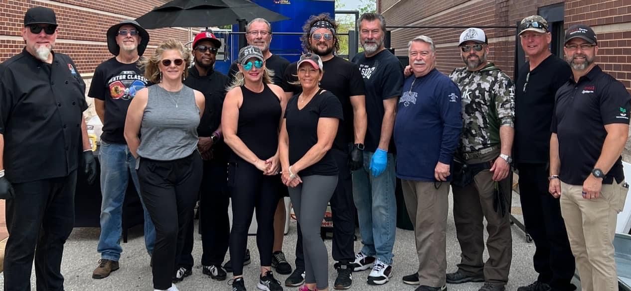 A group of people are posing for a picture in front of a building.