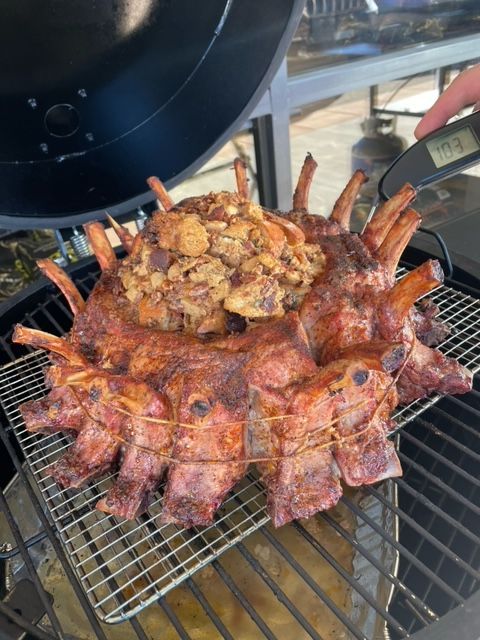 A bunch of meat is cooking on a grill