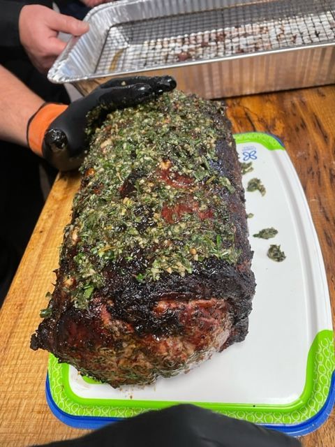A large piece of meat is sitting on a cutting board