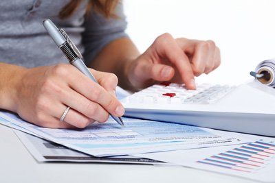 Woman making calculations Woman making calculations