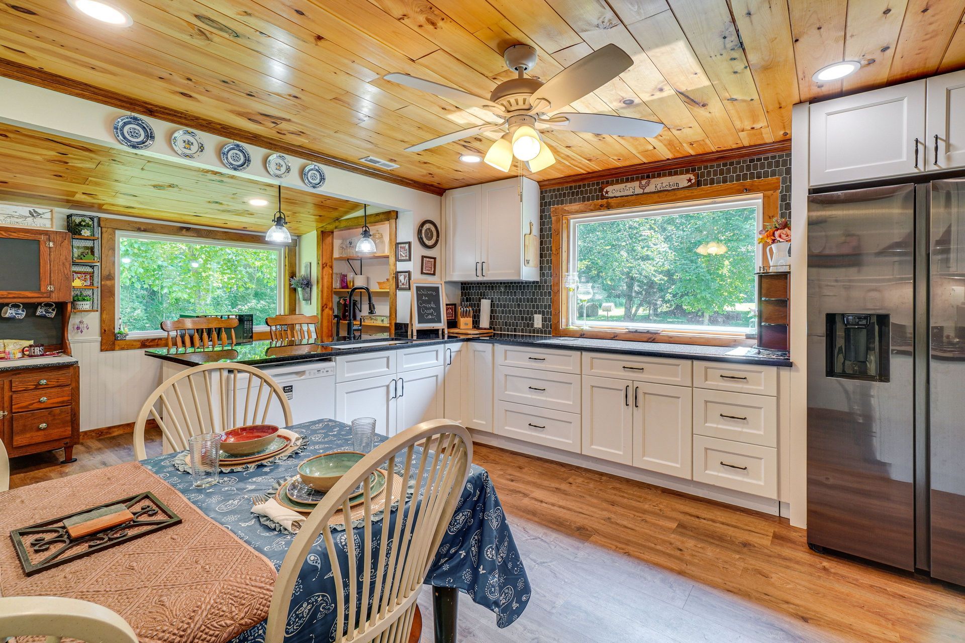 A kitchen with a table and chairs and a refrigerator.