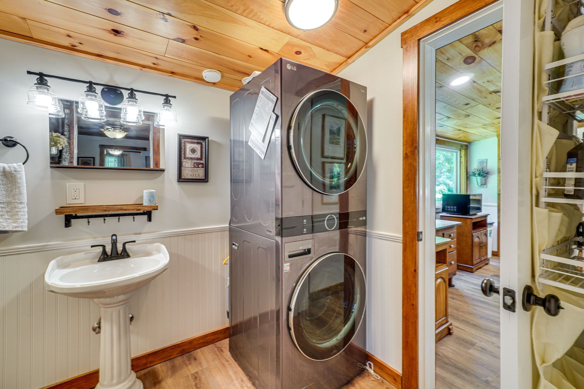 A bathroom with a washer and dryer stacked on top of each other.