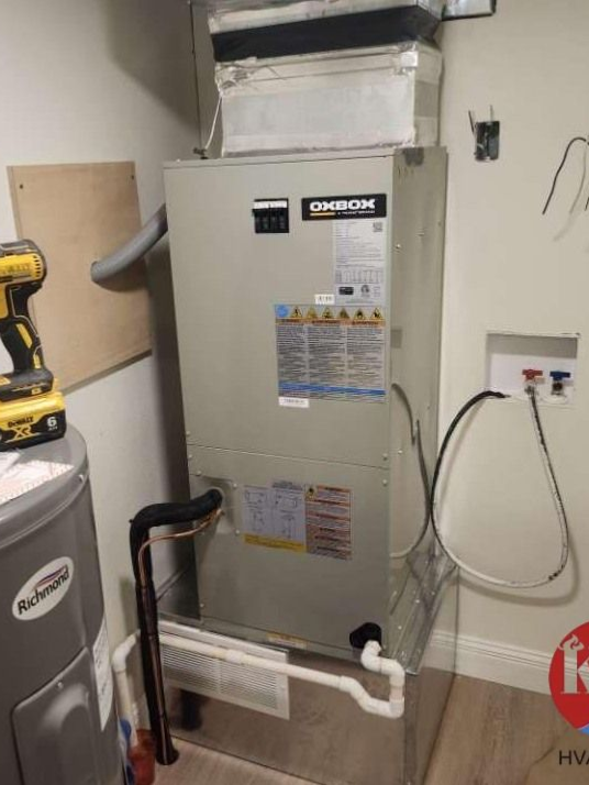 Woman in straw hat smiles, holding wine glass near a lake.