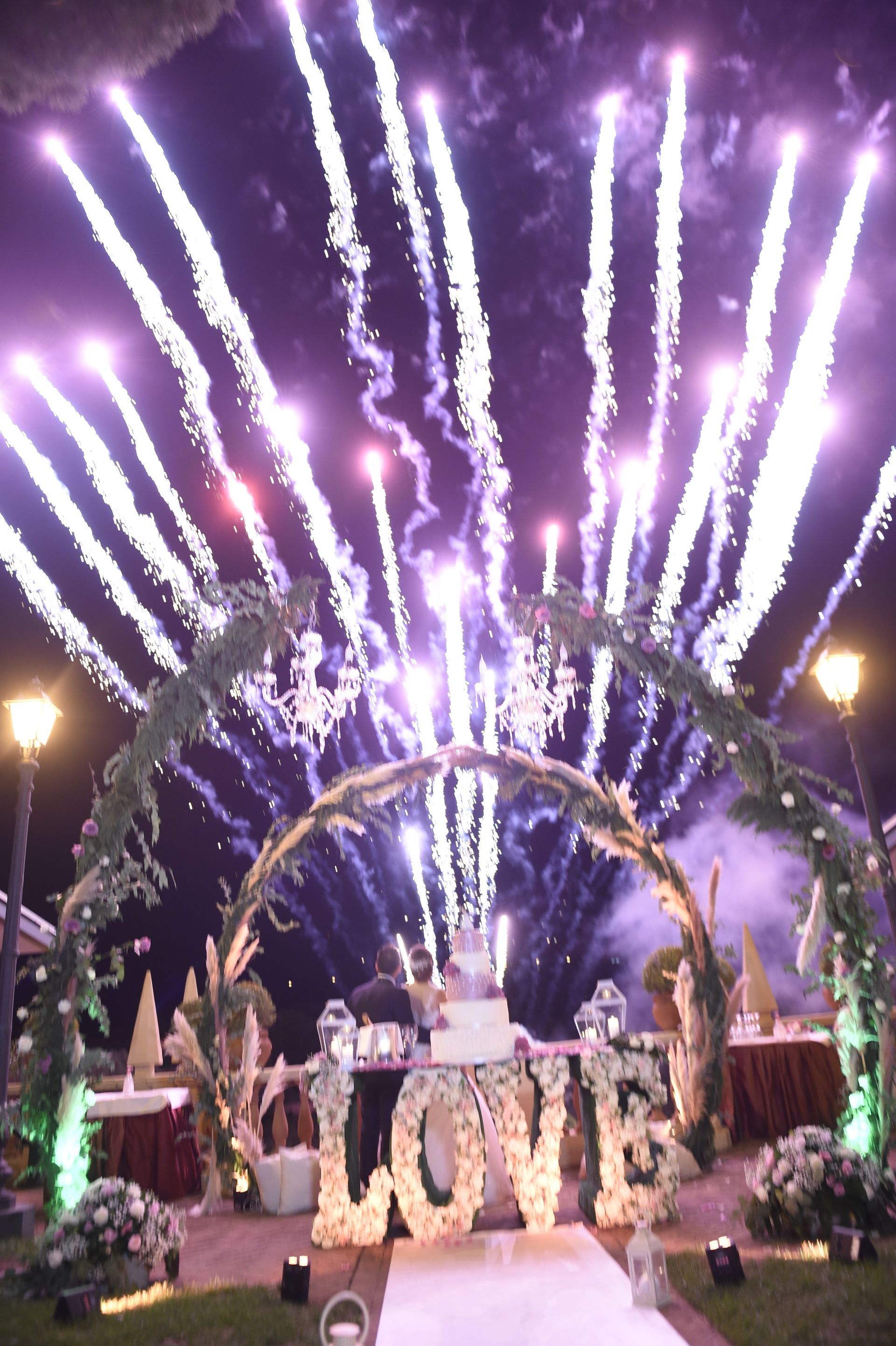 Un ricevimento di nozze con fuochi d'artificio e un cartello che dice amore