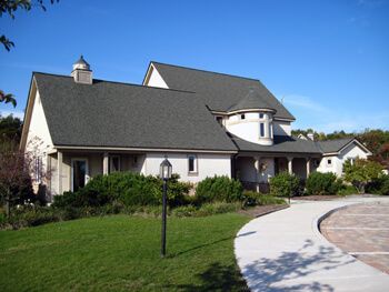 A large white house with a gray roof