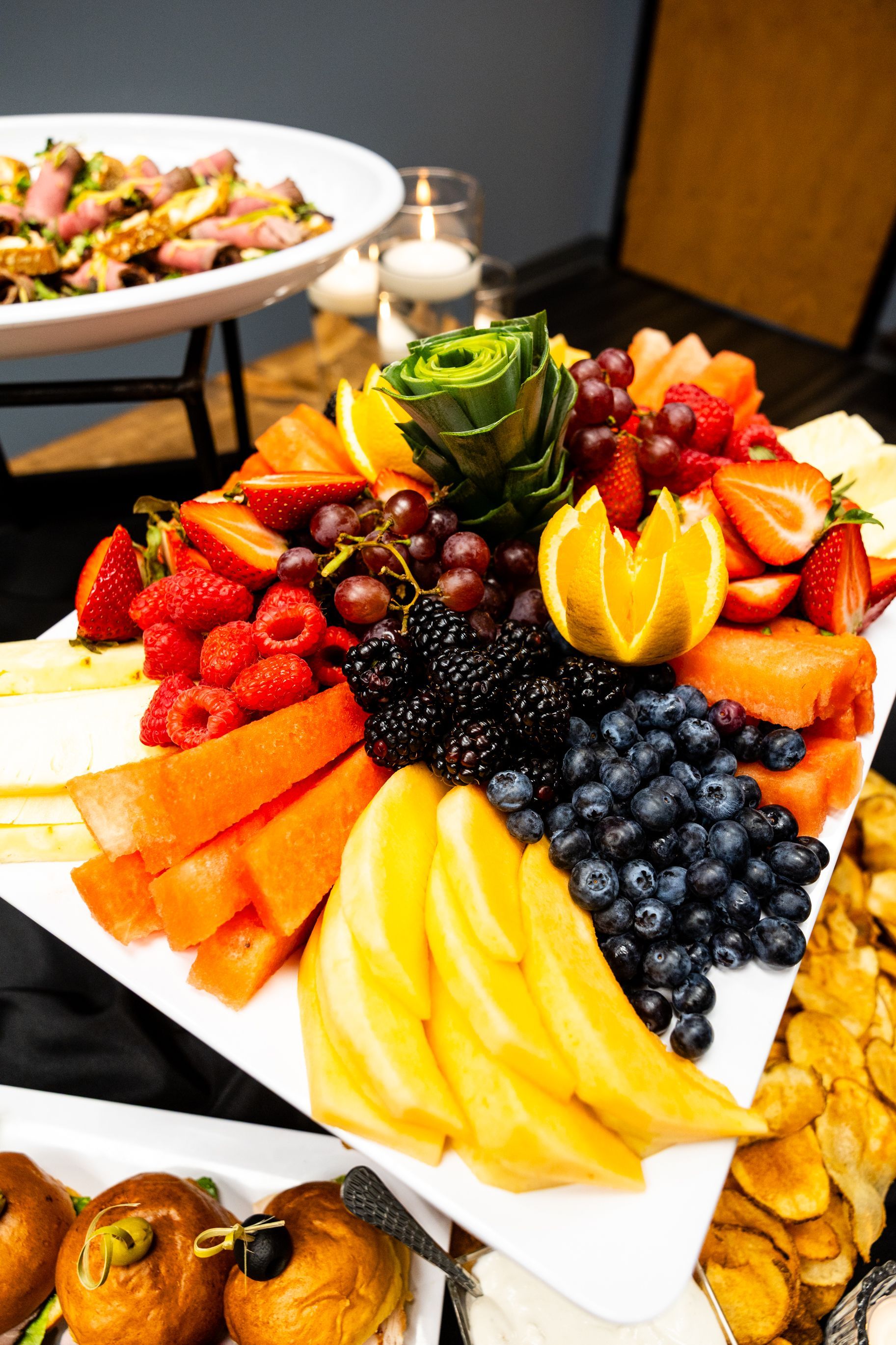 A tray of food on skewers on a table.