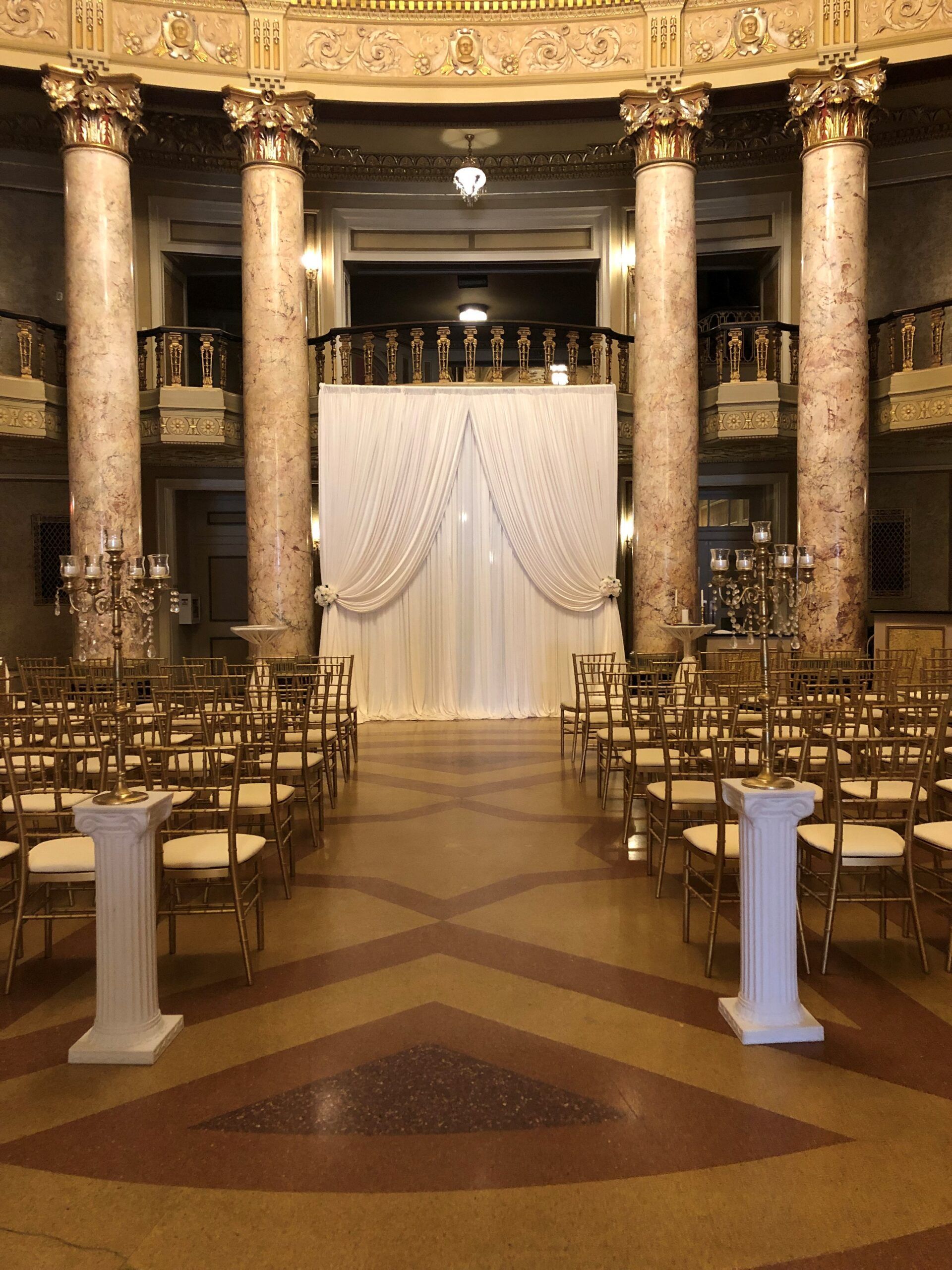 A large room with rows of chairs and columns