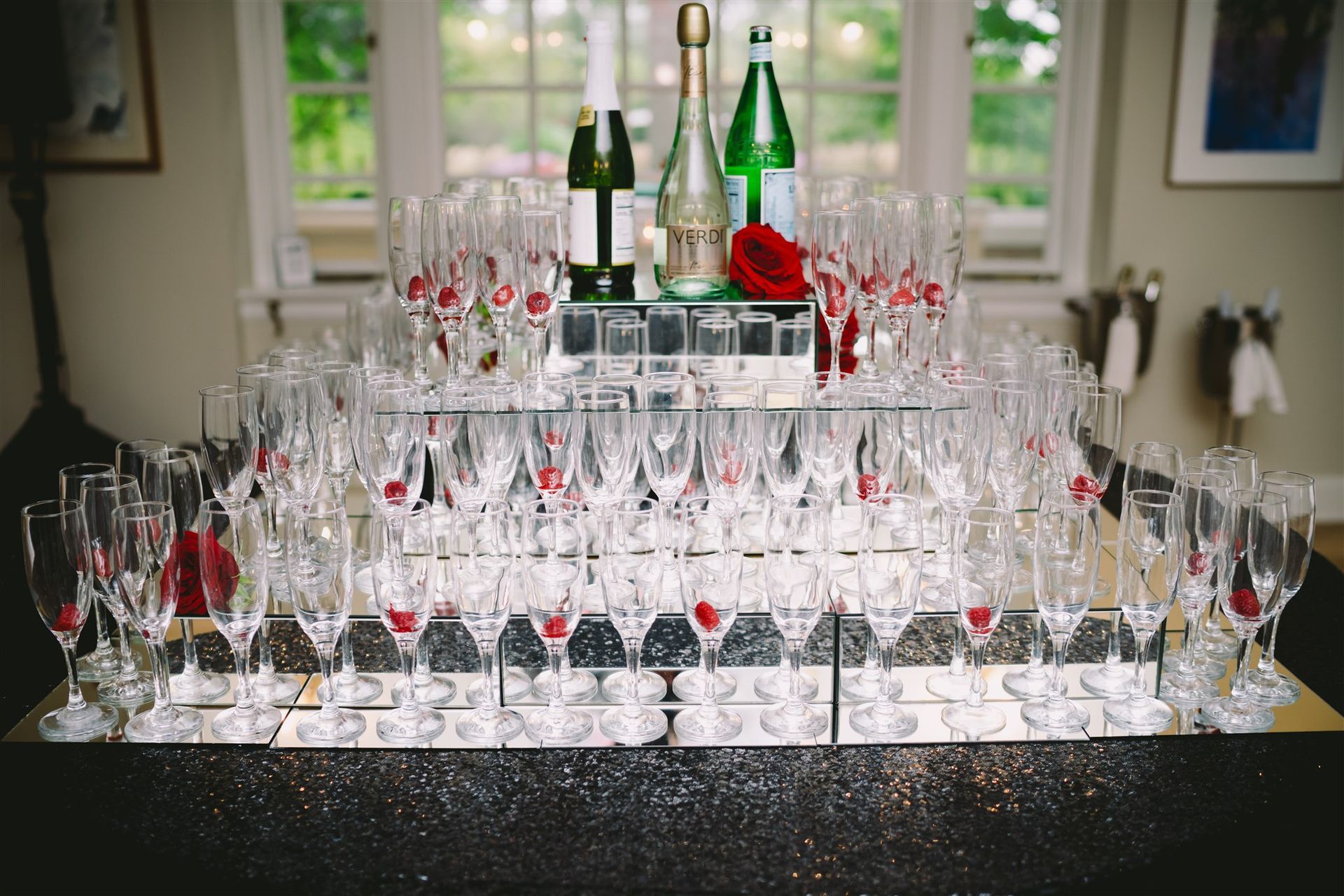 A person is pouring a bottle of wine into a glass