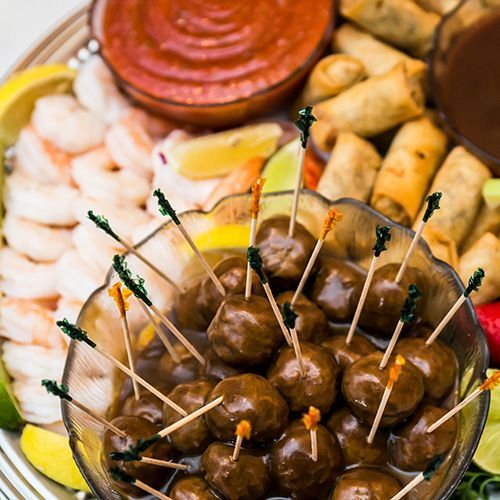 There is a bowl of meatballs with toothpicks in it.