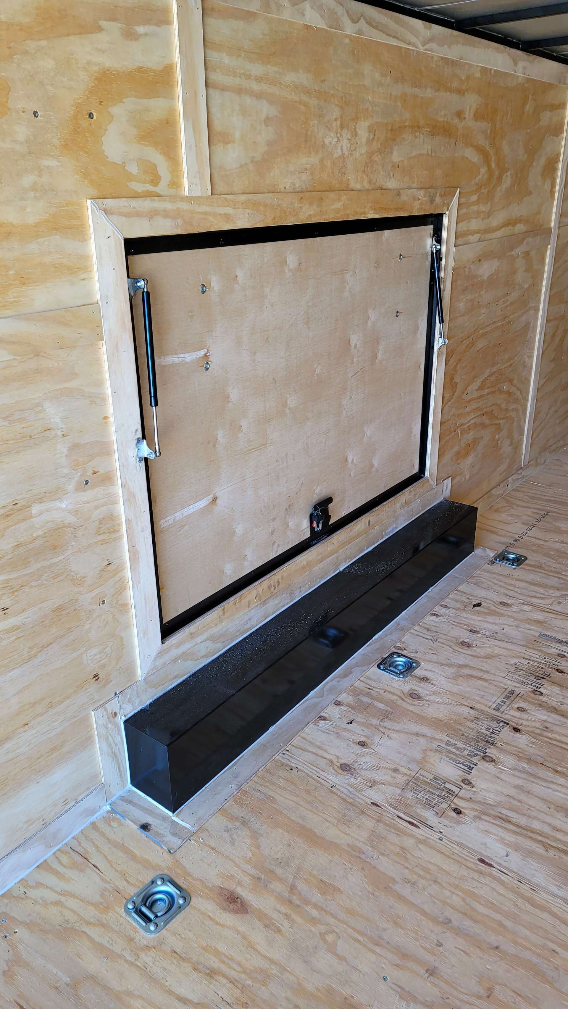 There is a door in the wall of a trailer.