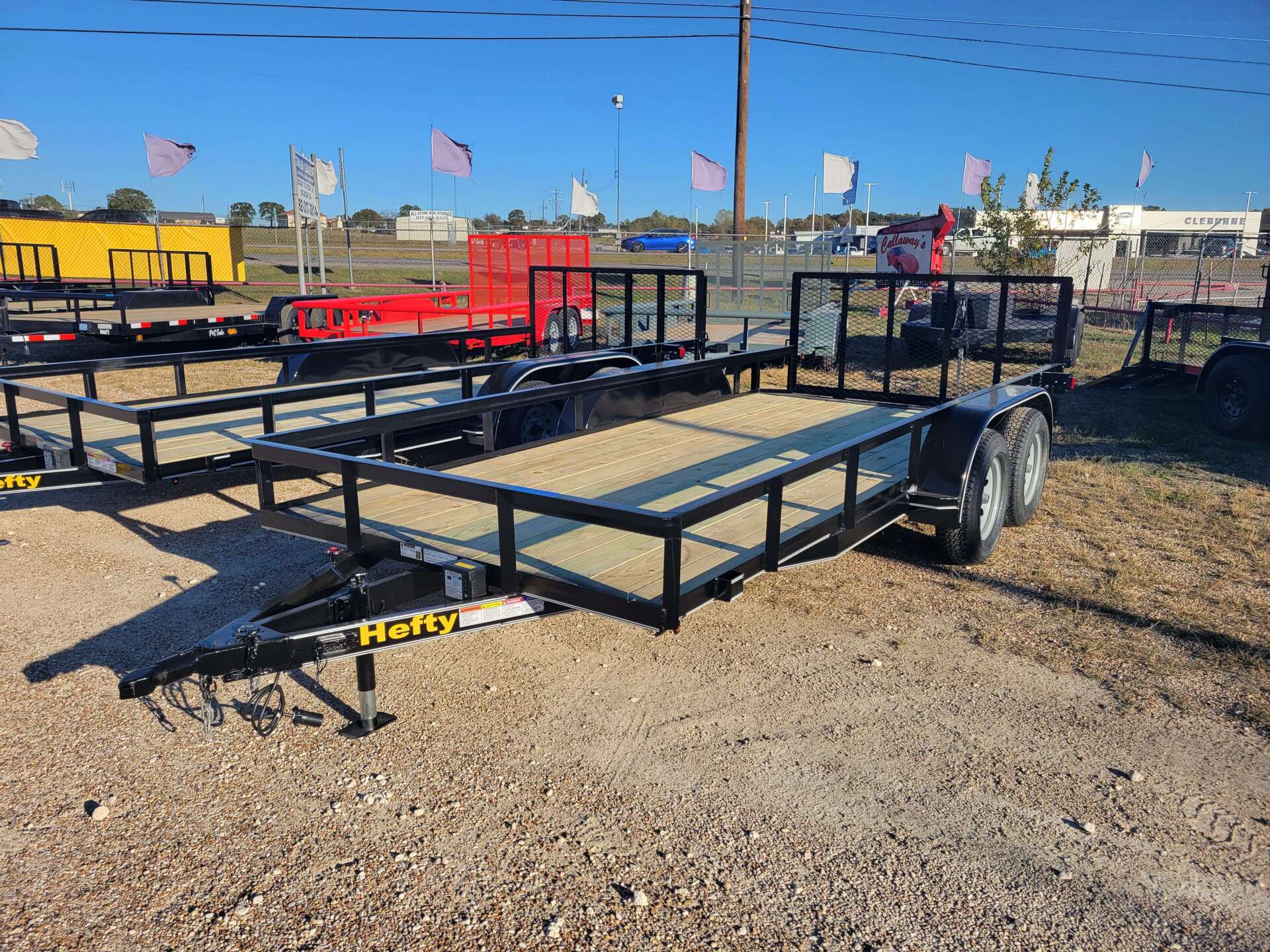 A trailer is parked in a gravel lot.