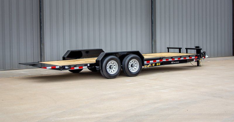 A flatbed trailer is parked in front of a building.