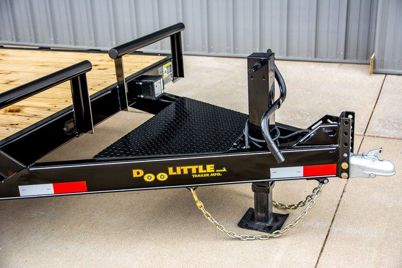 A doolittle trailer is parked on a concrete surface.