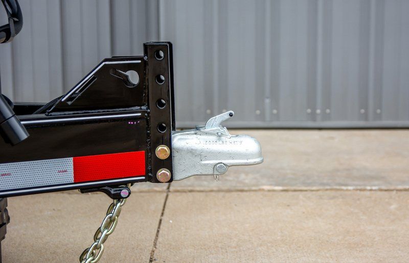 A close up of a trailer hitch on a sidewalk.