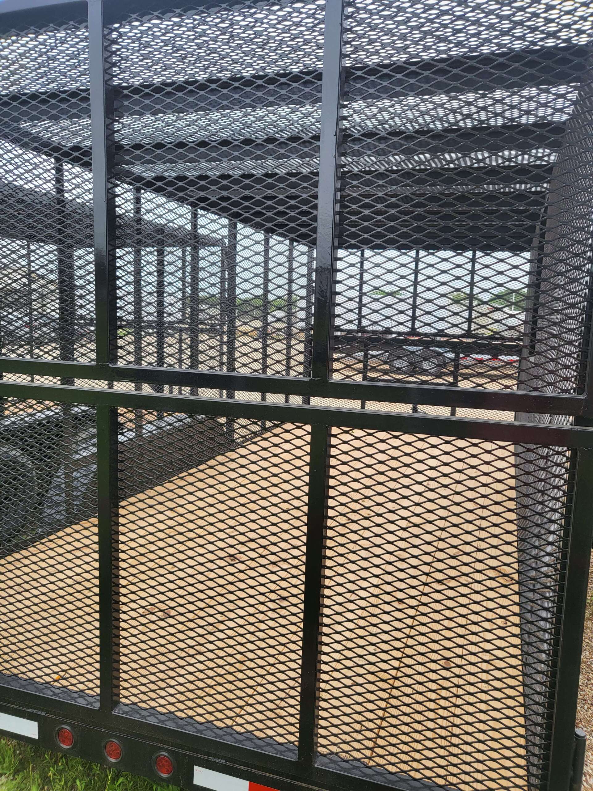 A close up of a metal fence surrounding a trailer