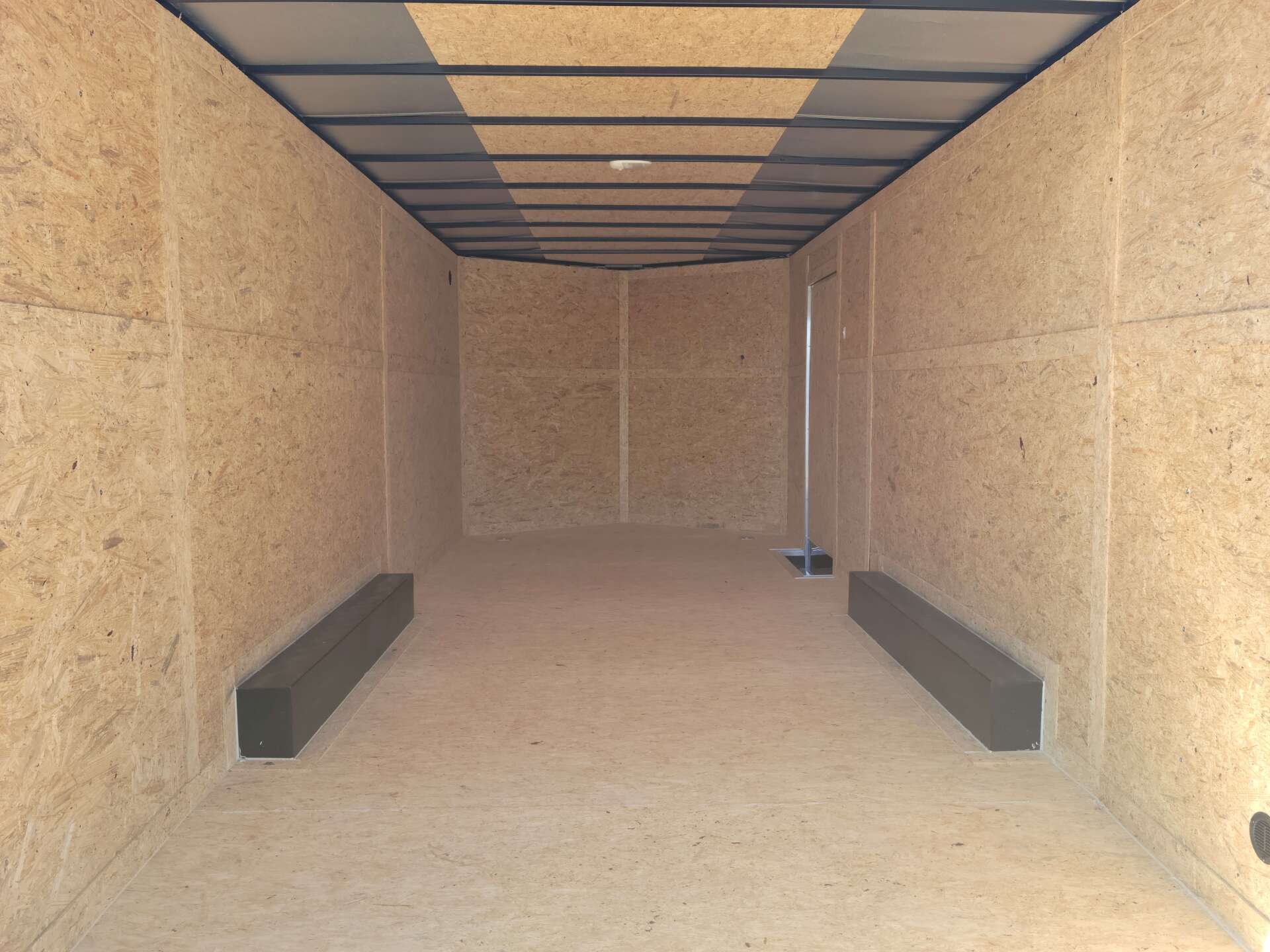 A very long empty room with a ceiling that is very high