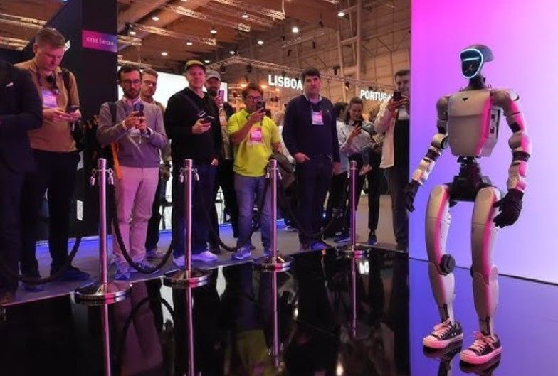 Robot hand, white and black, extended forward.