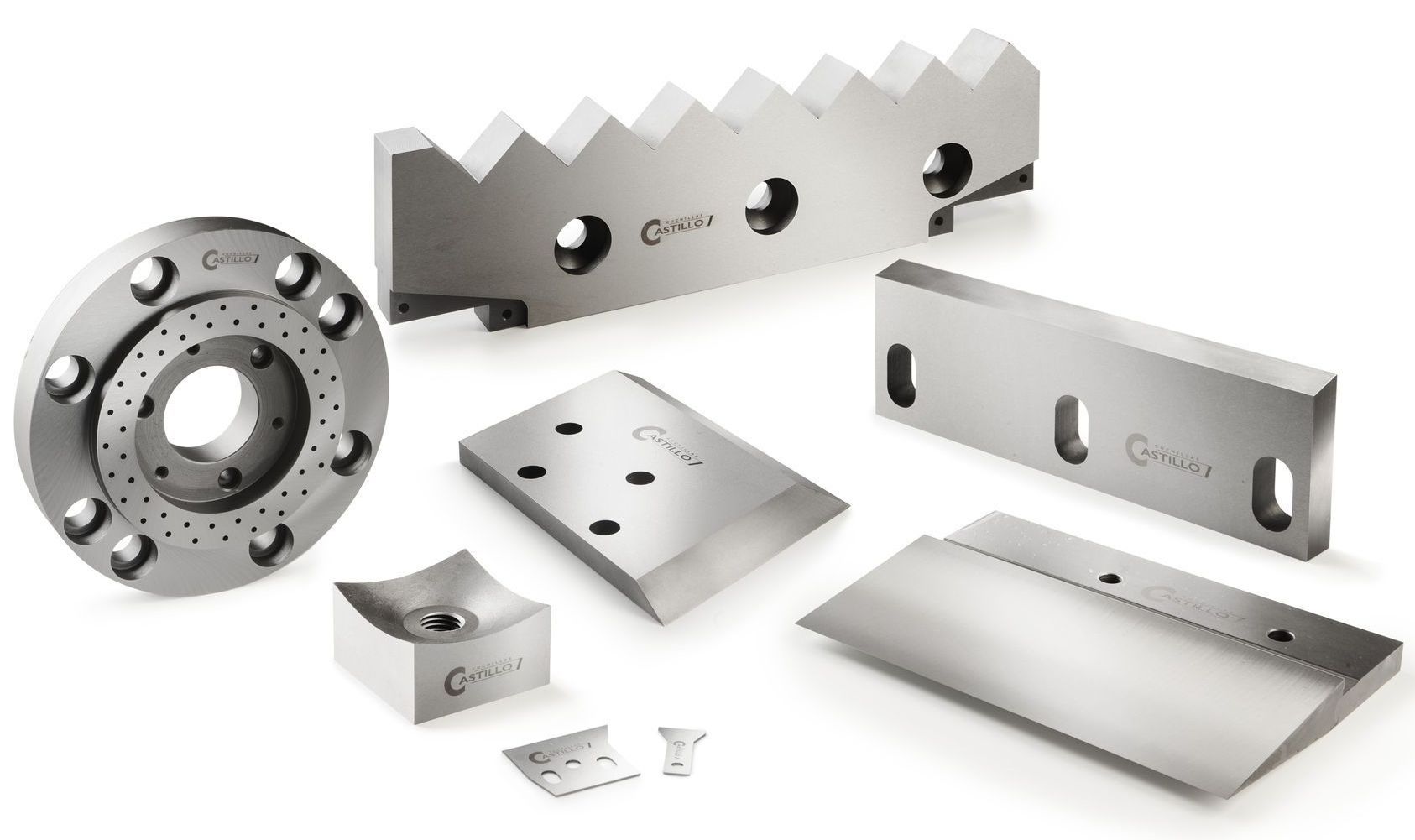 Varias cuchillas y piezas industriales de metal sobre un fondo blanco.