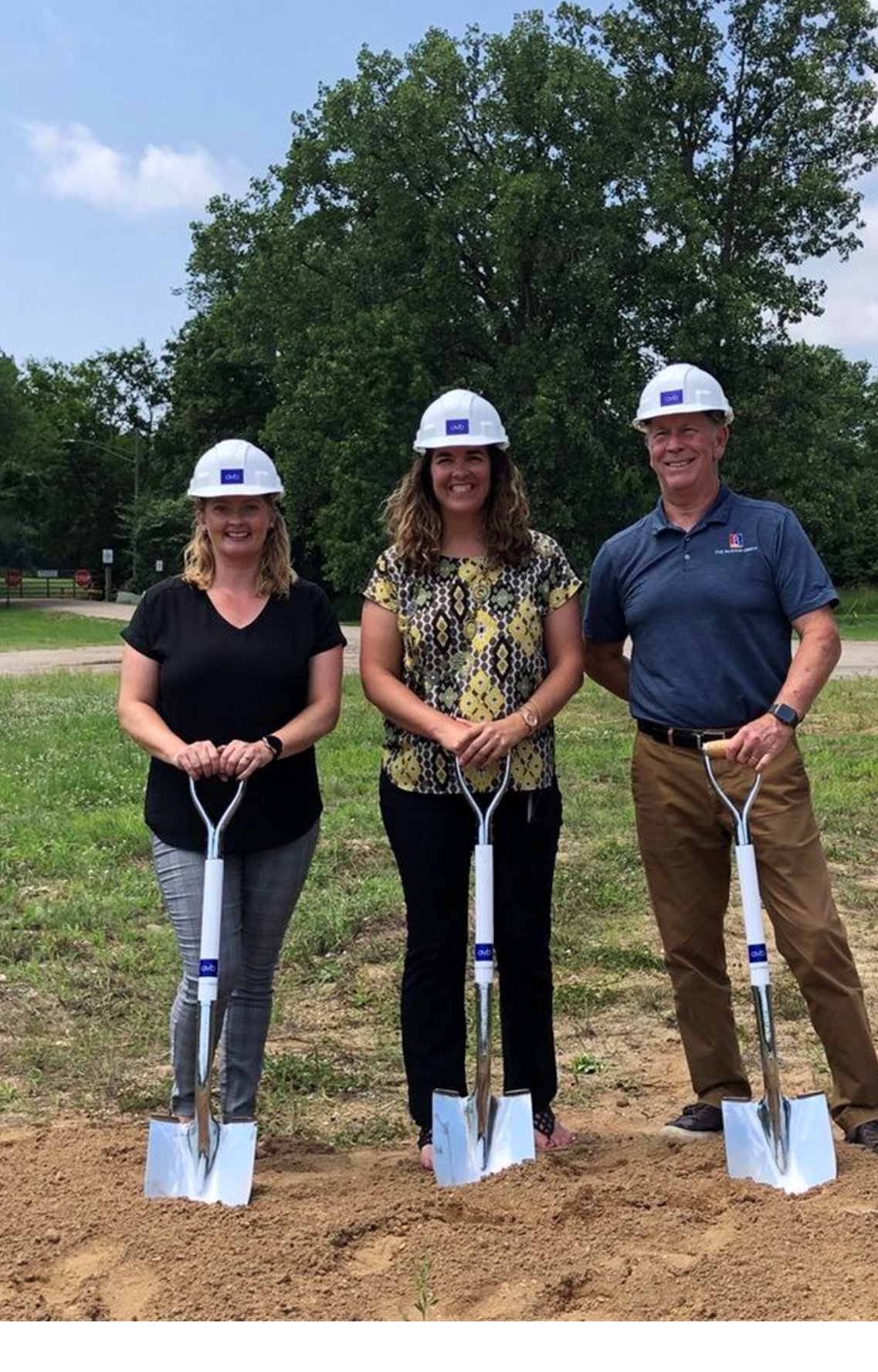 TBG leadership at a groundbreaking with hard hats and shovels