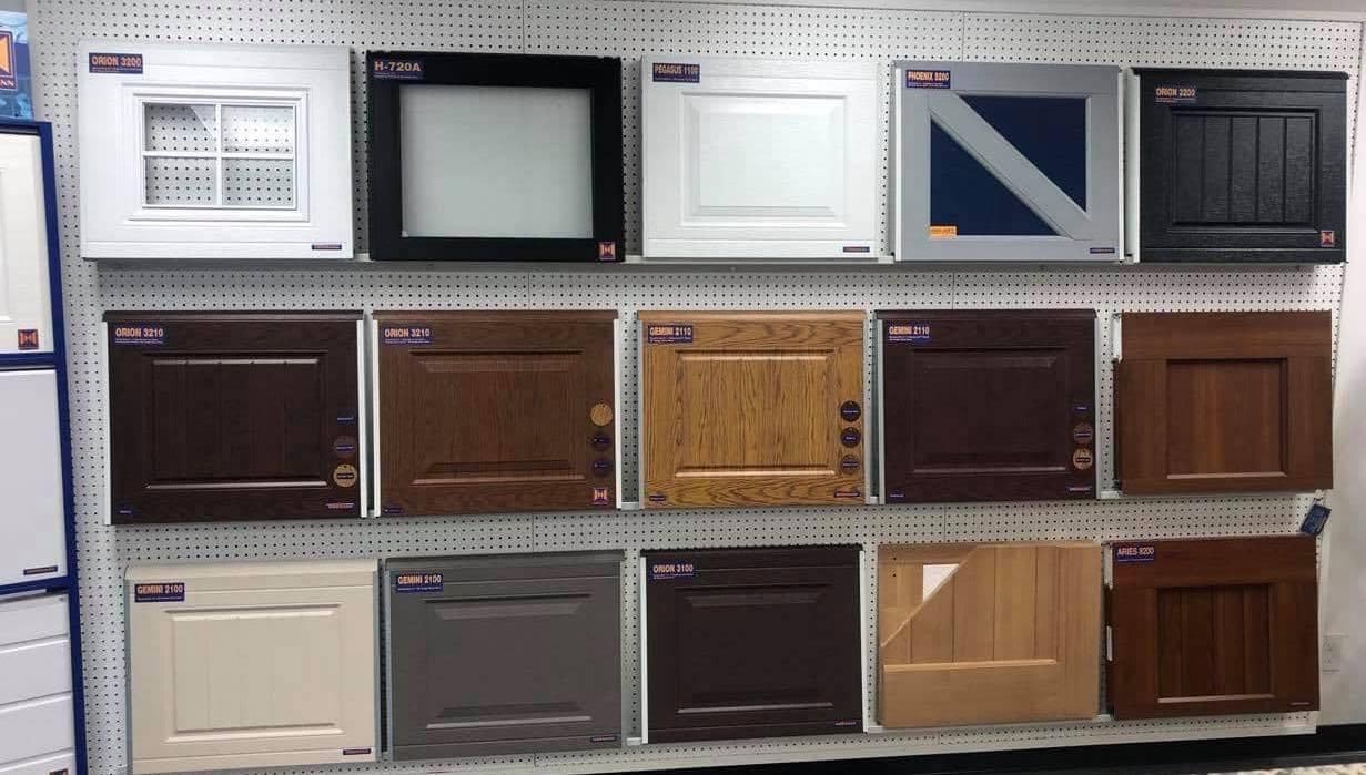 Display of various square cabinet door samples with different colors and styles.