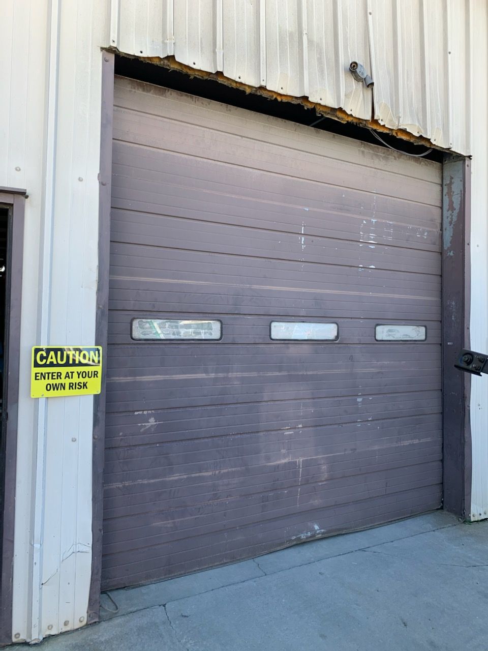 Purple garage door on a building with a 