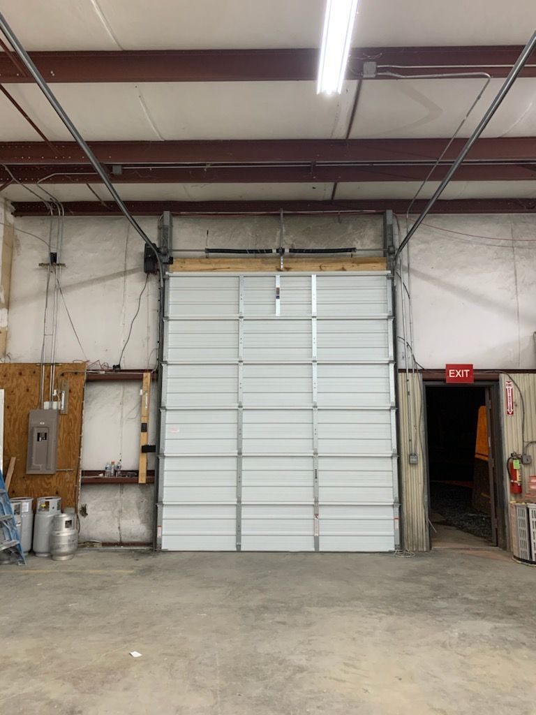 Closed overhead garage door inside a commercial building. 