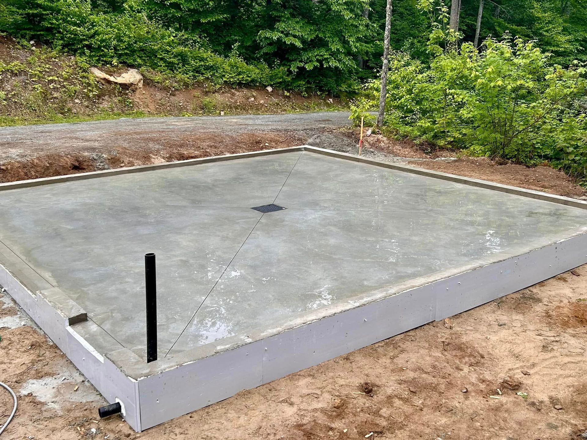 Une dalle de béton est posée au milieu d'un champ de terre.