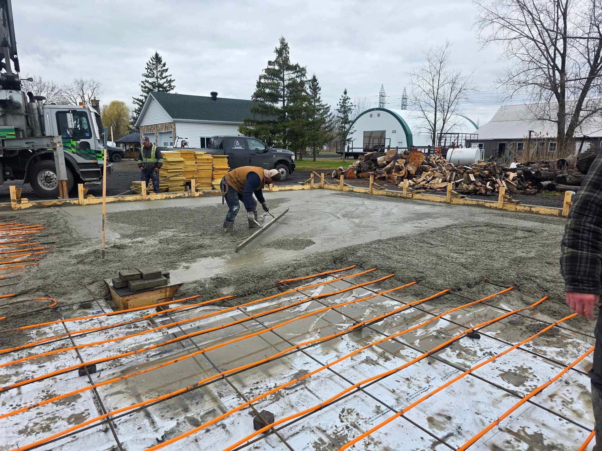 A man is spreading concrete on a construction site.