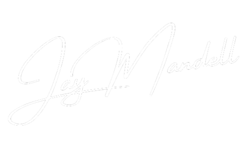 A white signature on a white background.