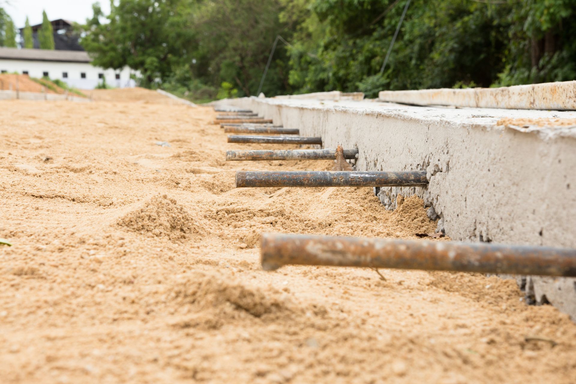 A row of metal bars sitting on top of a concrete slab.