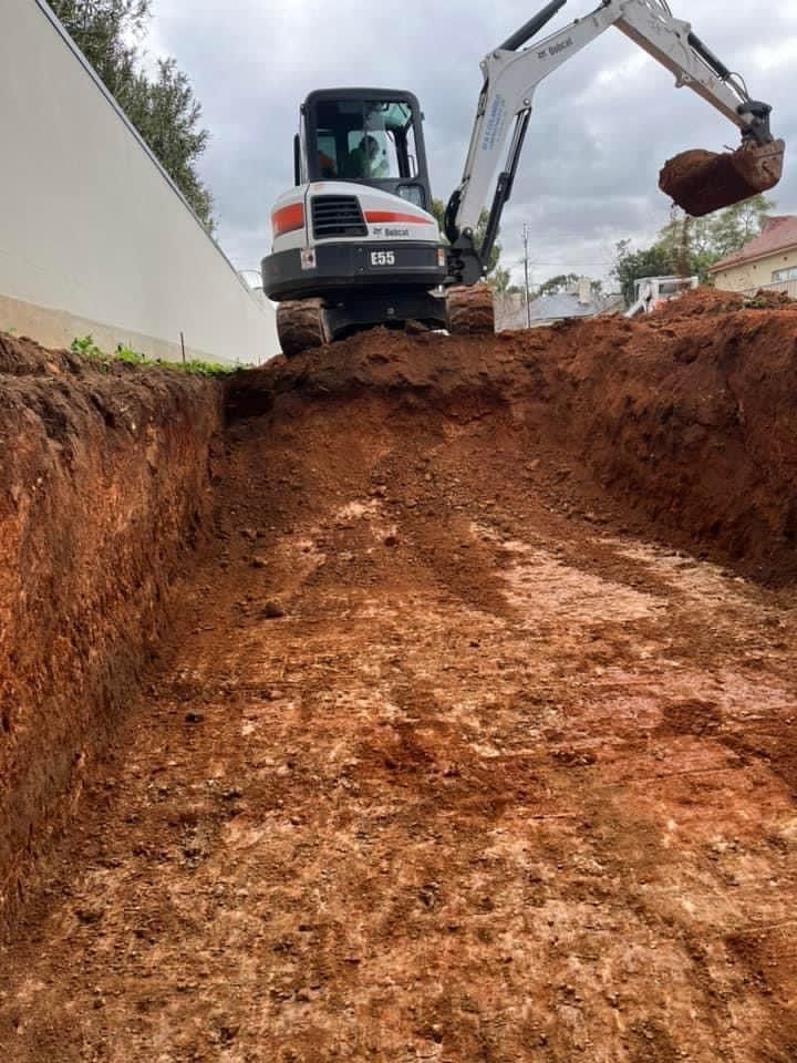 A bulldozer is digging a hole in the ground.